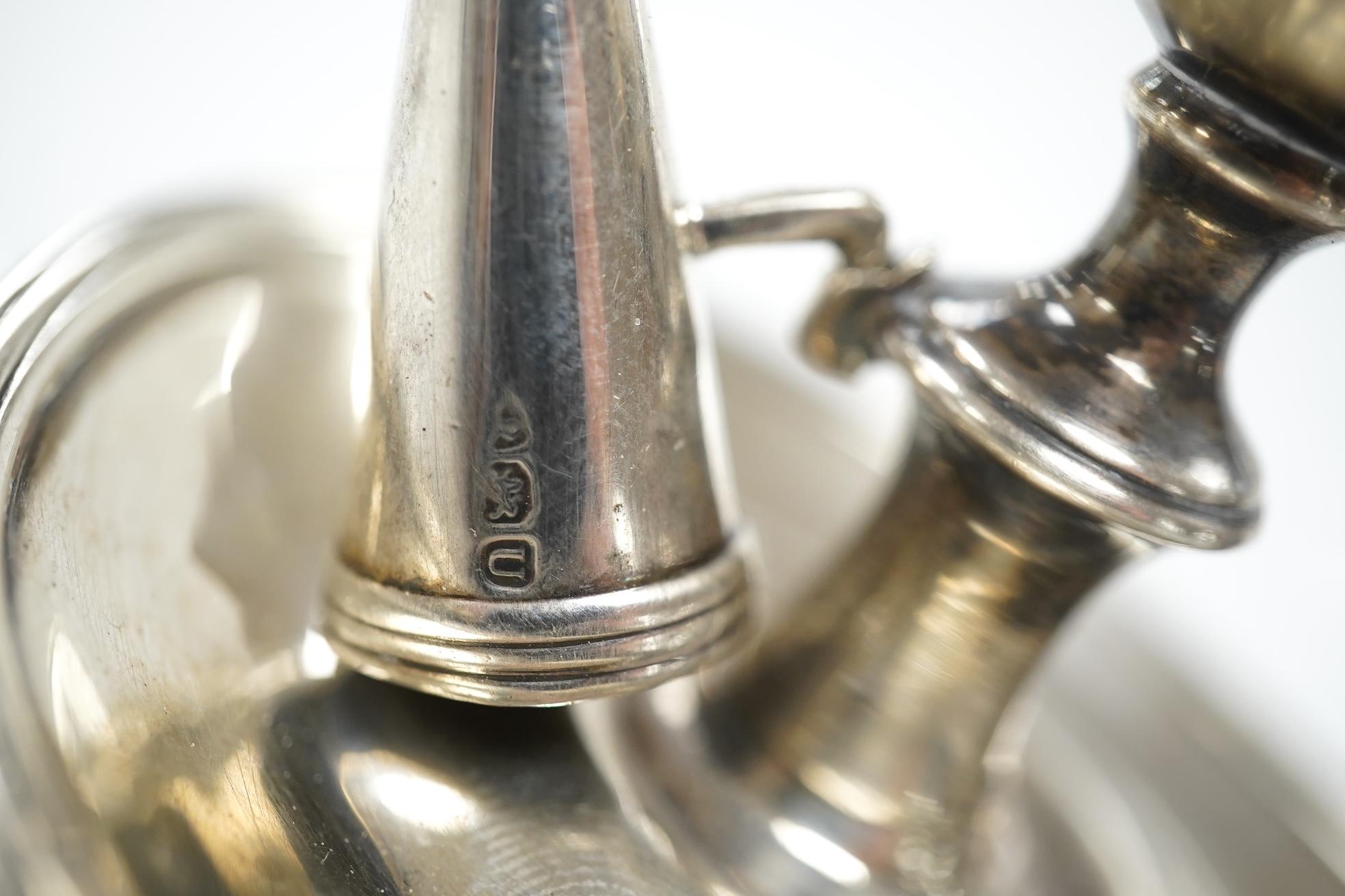 A George III miniature silver chamber stick, Emes & Barnard, London, 1815(a.f.), with matching extinguisher, base diameter 75mm. Condition - poor